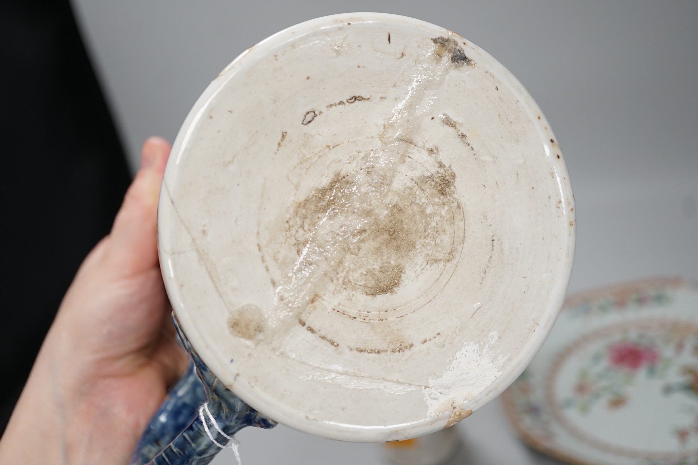 A Chinese figure of blanc de chine, a dragon tea bowl, a saucer, a large tankard, and another Chinese dish, tallest 23cm